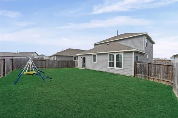 a view of a house with a backyard