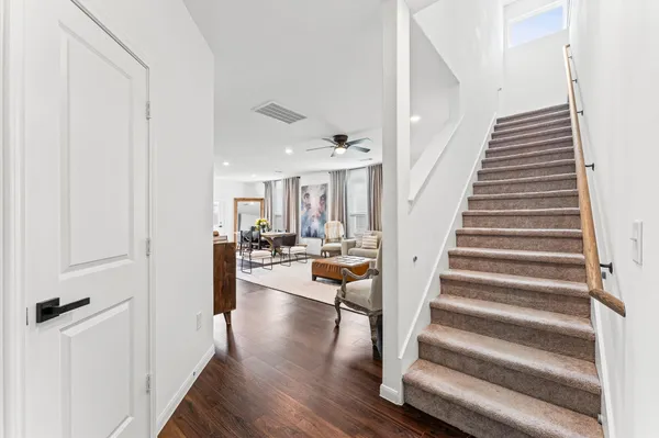 a view of entryway and hall with wooden floor