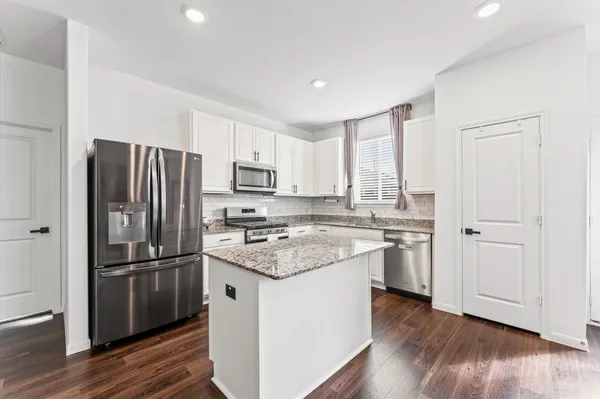 a kitchen with wooden cabinets and stainless steel appliances