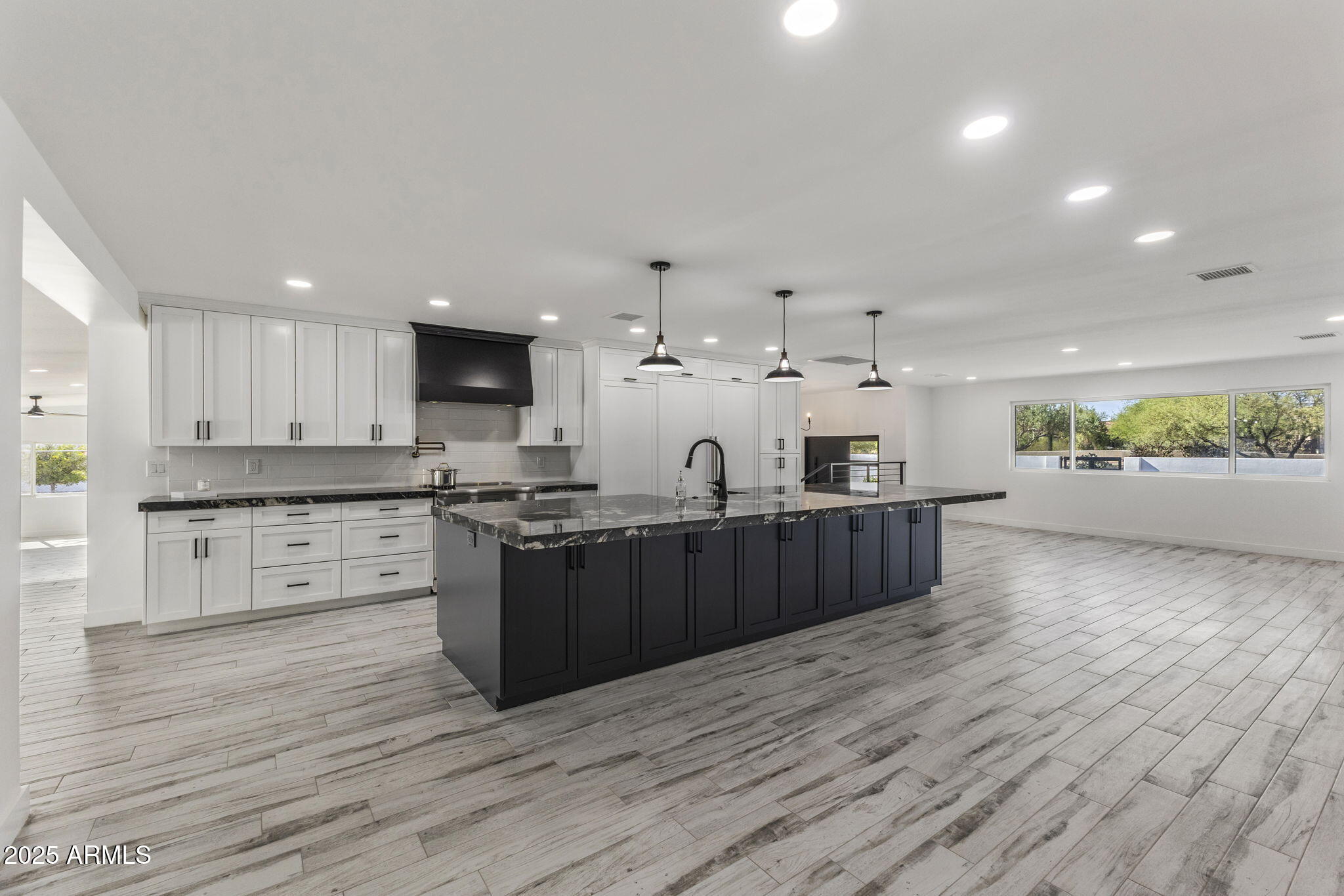 5219 East Lone Mountain Road Cave Creek, AZ 85331 - Photo 15 of 88 a large kitchen with stainless steel appliances kitchen island granite countertop a large counter top and wooden floors