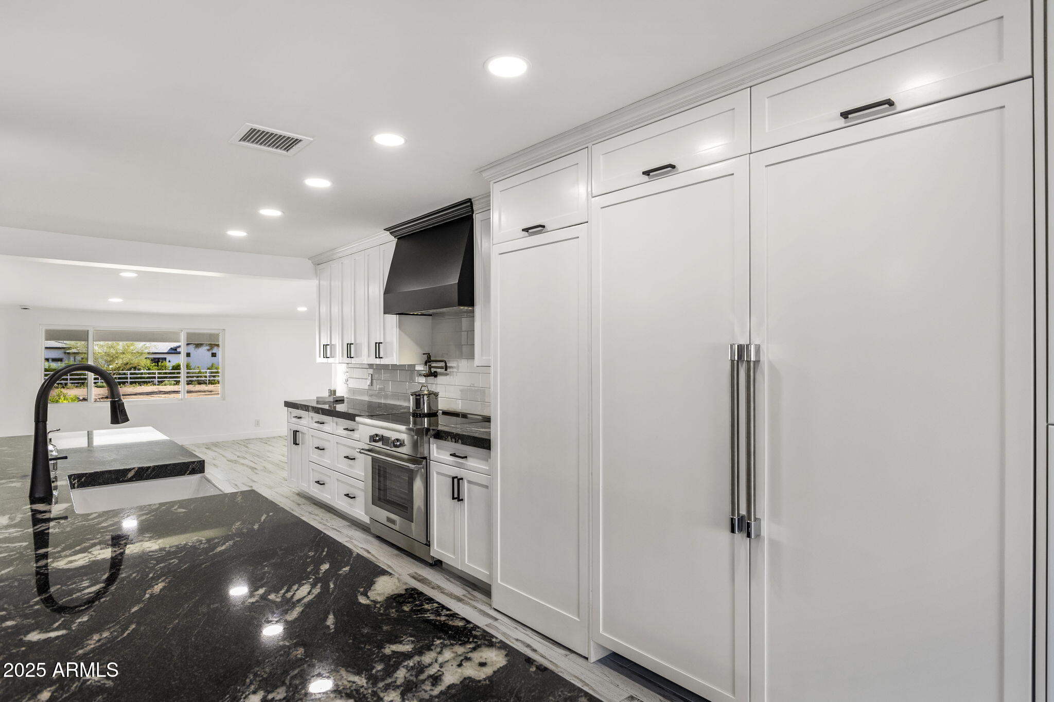 5219 East Lone Mountain Road Cave Creek, AZ 85331 - Photo 17 of 88 a kitchen with stainless steel appliances a refrigerator and white cabinets