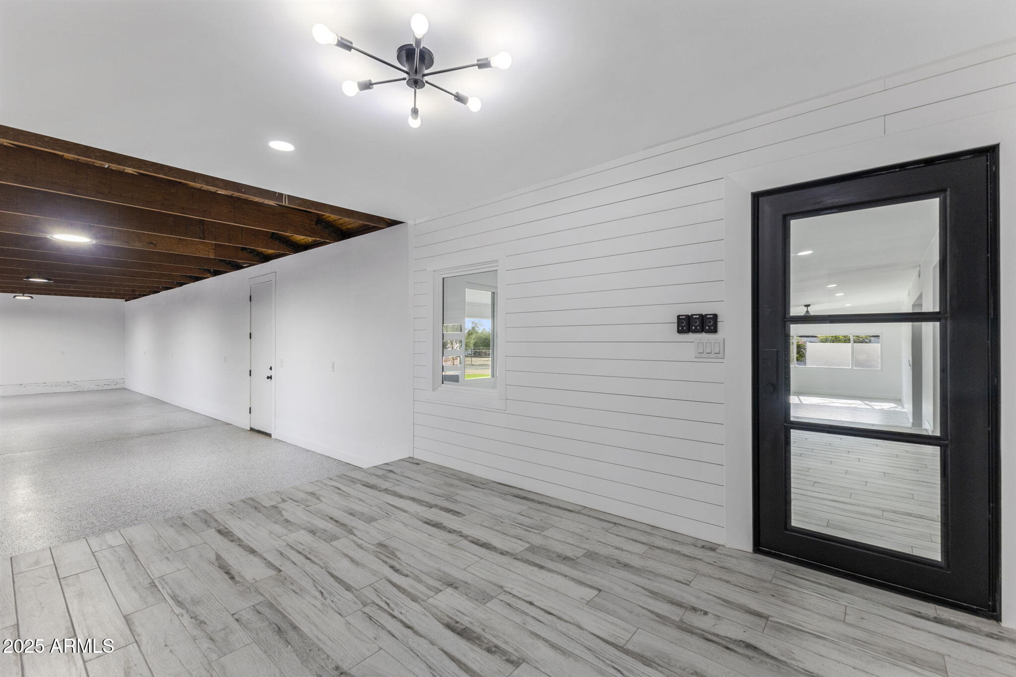 5219 East Lone Mountain Road Cave Creek, AZ 85331 - Photo 51 of 88 an empty room with wooden floor and windows