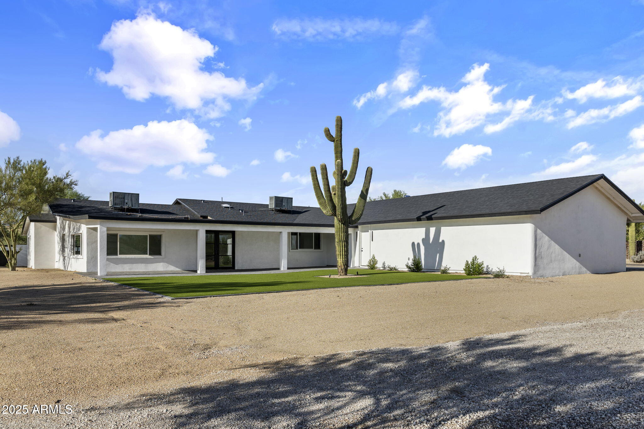 5219 East Lone Mountain Road Cave Creek, AZ 85331 - Photo 57 of 88 a front view of a house with a yard and garage