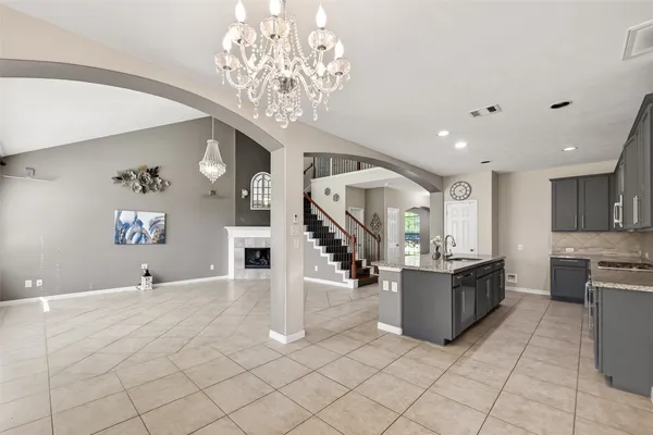 a large kitchen with a sink and cabinets