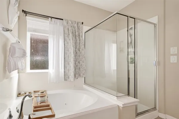 a bathroom with a tub and a shower