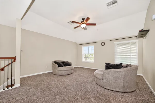 a view of a room with a ceiling fan
