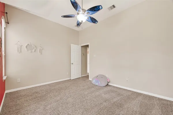 a view of a room with a ceiling fan