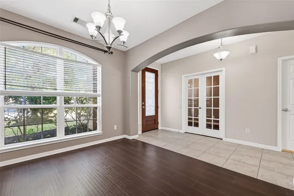 a view of a livingroom with wooden floor and a large window