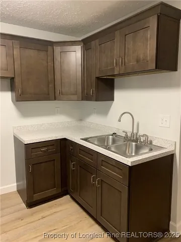 a kitchen with a sink and cabinets