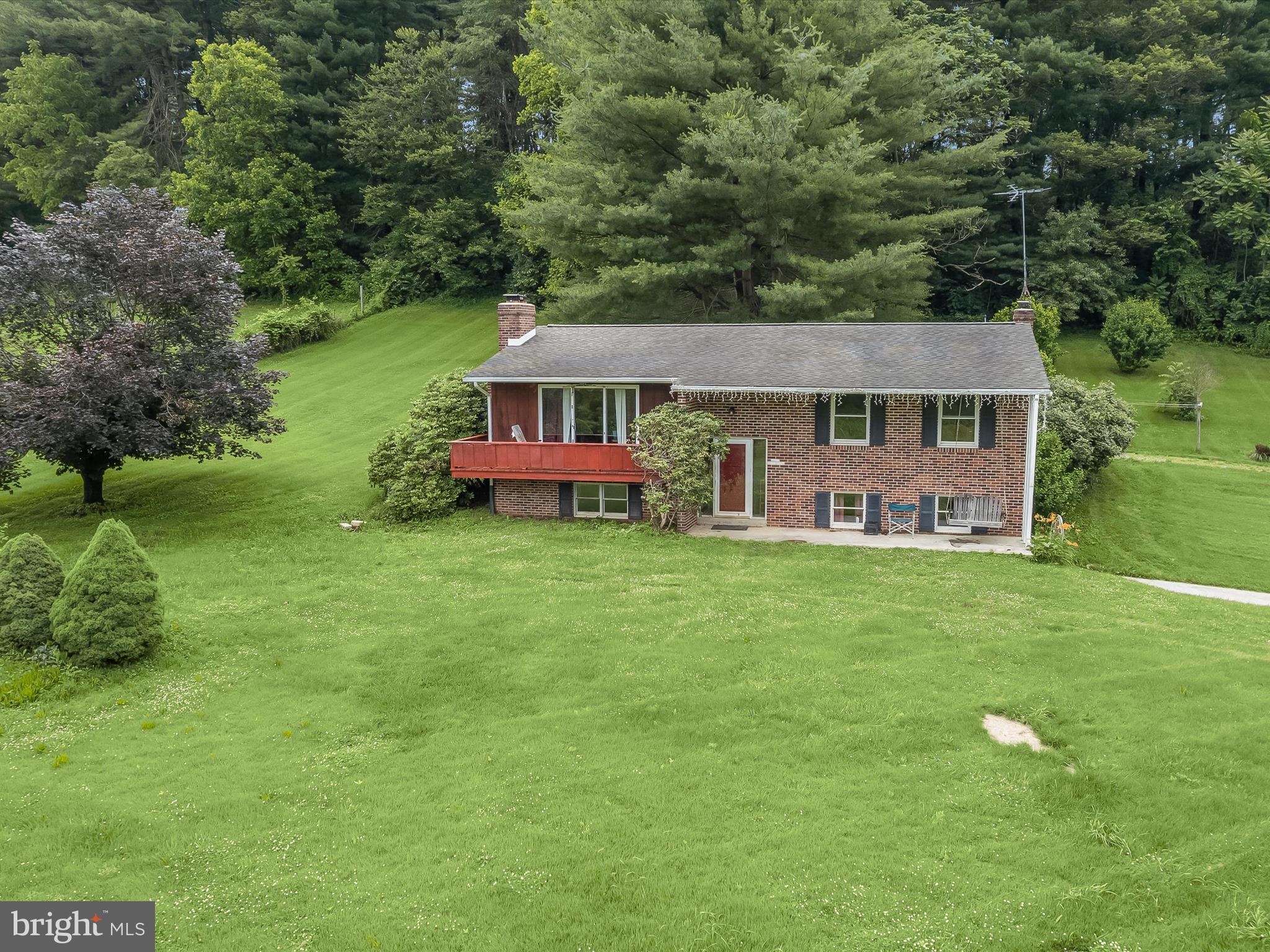 an aerial view of a house with swimming pool garden and patio