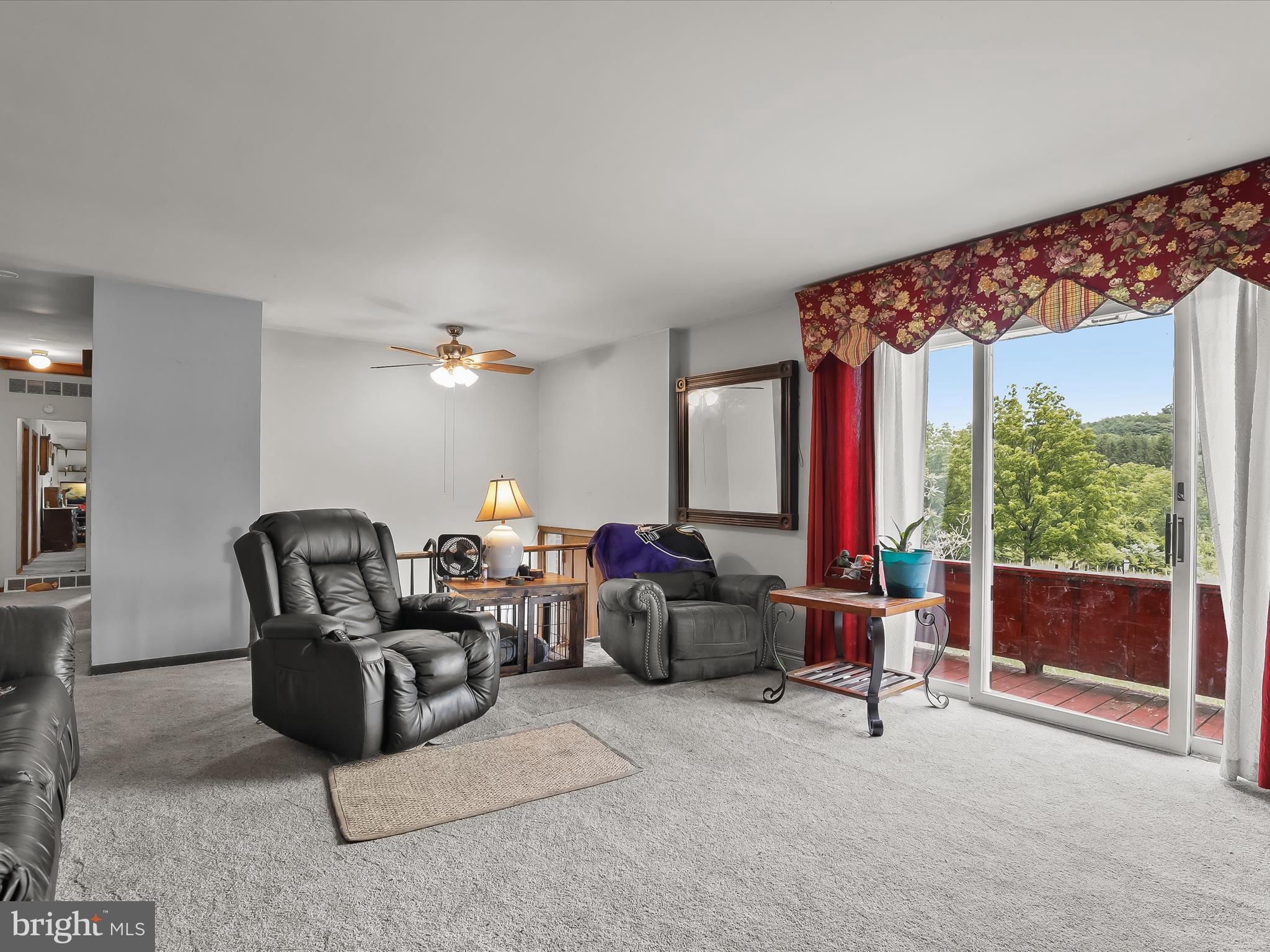 4704 Baughman Mill Road Manchester, MD 21102 - Photo 15 of 64 a living room with furniture a lamp and a large window