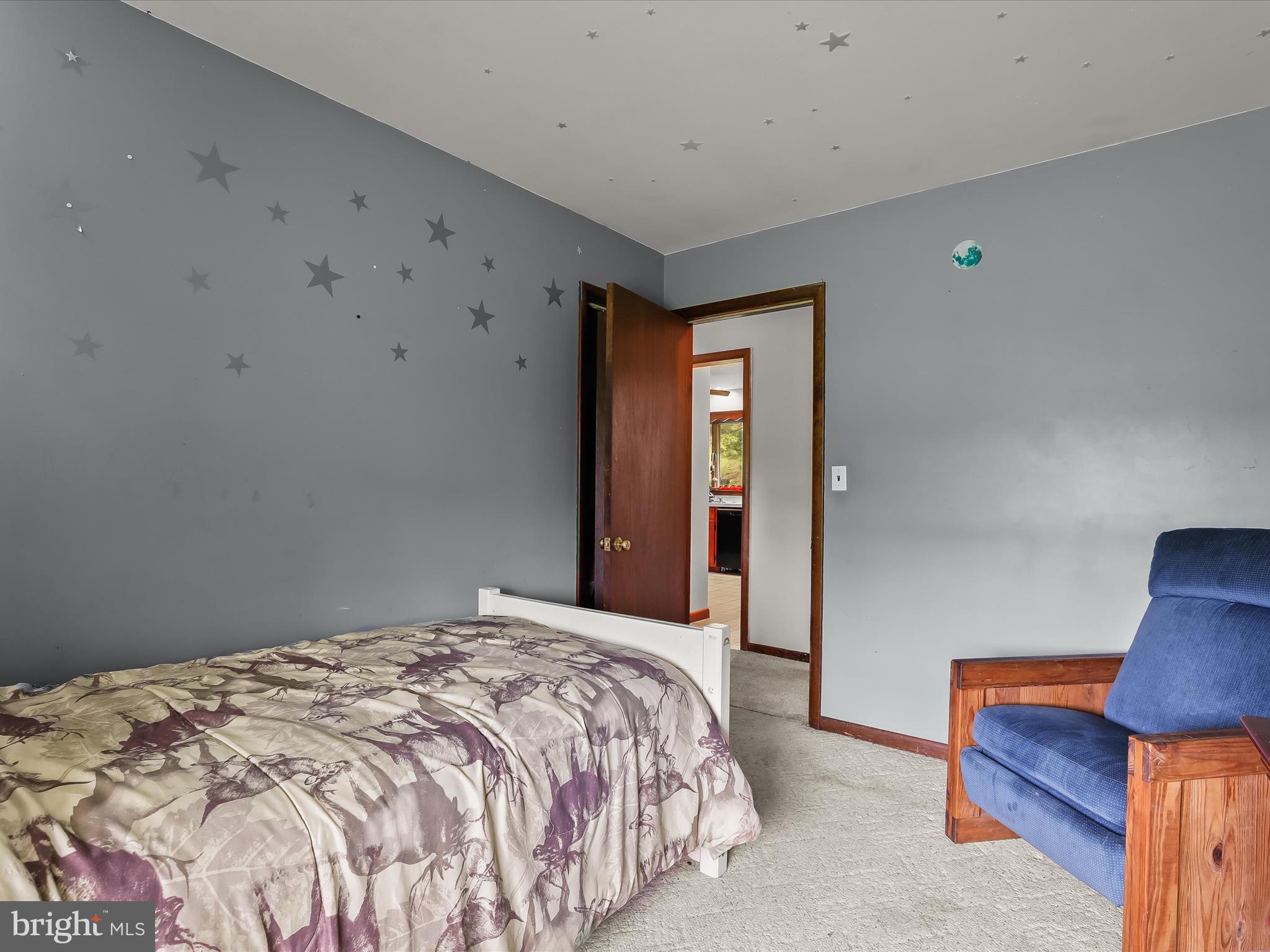 4704 Baughman Mill Road Manchester, MD 21102 - Photo 26 of 64 a bedroom with a bed and a lamp on dresser