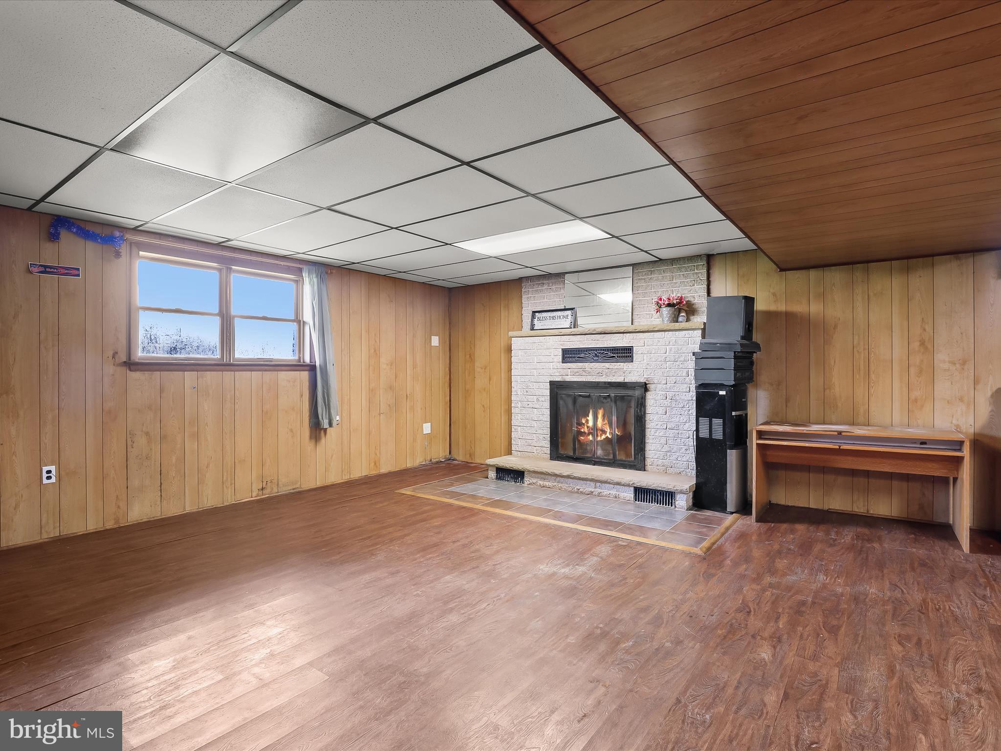 4704 Baughman Mill Road Manchester, MD 21102 - Photo 32 of 64 a view of an empty room with a fireplace and a window
