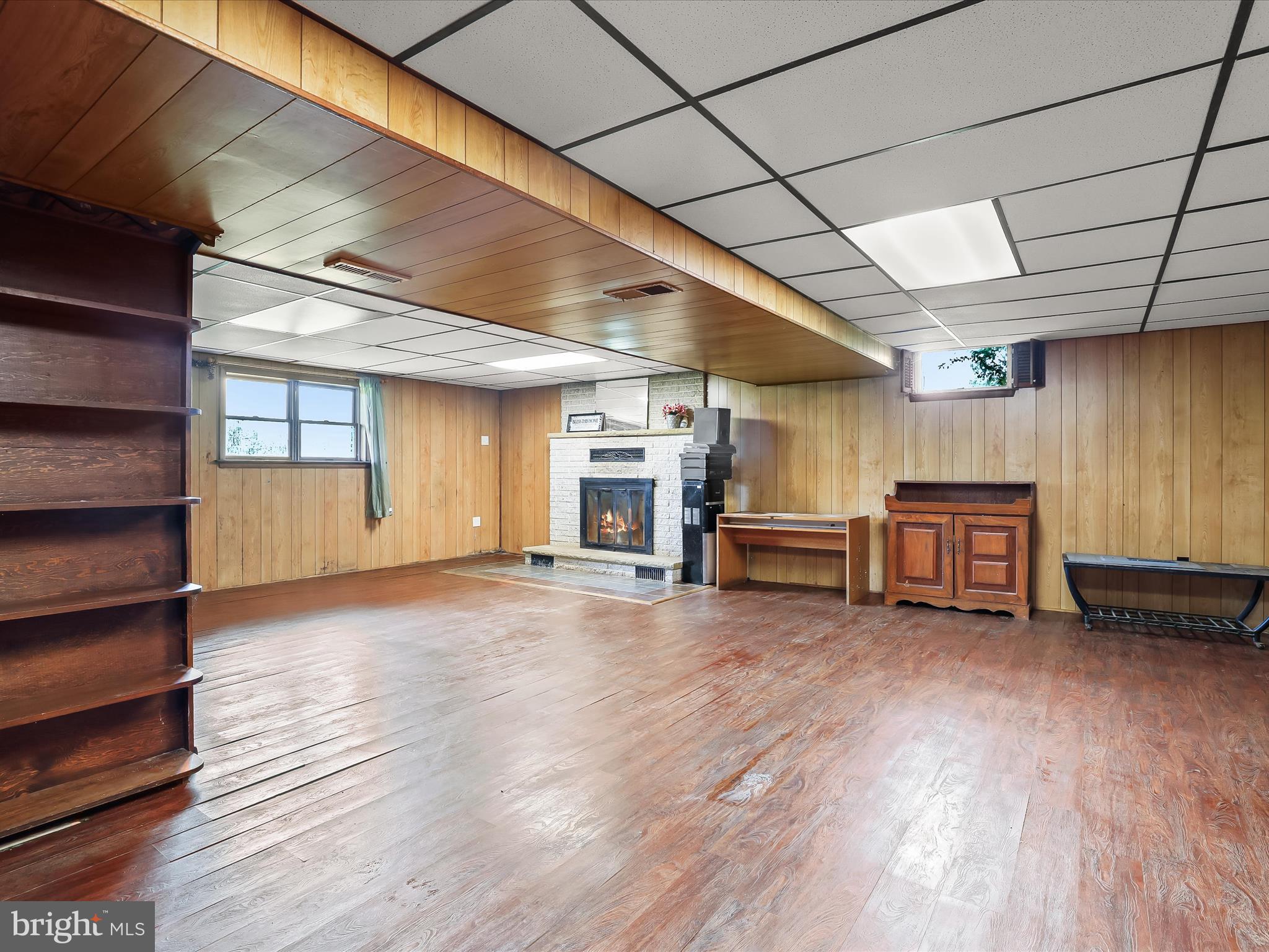 4704 Baughman Mill Road Manchester, MD 21102 - Photo 34 of 64 a view of empty room with wooden floor and fireplace