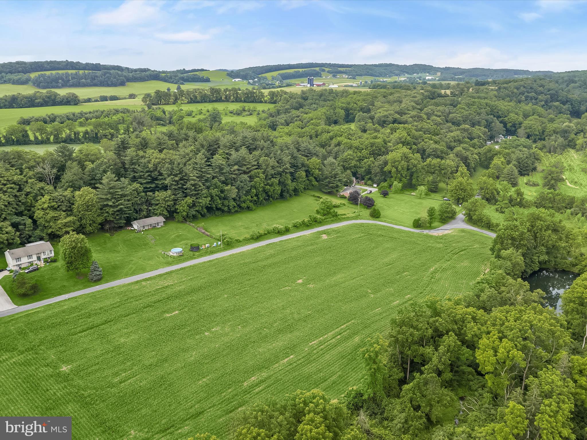 4704 Baughman Mill Road Manchester, MD 21102 - Photo 46 of 64 a view of a lush green outdoor space with a lake view and mountain view