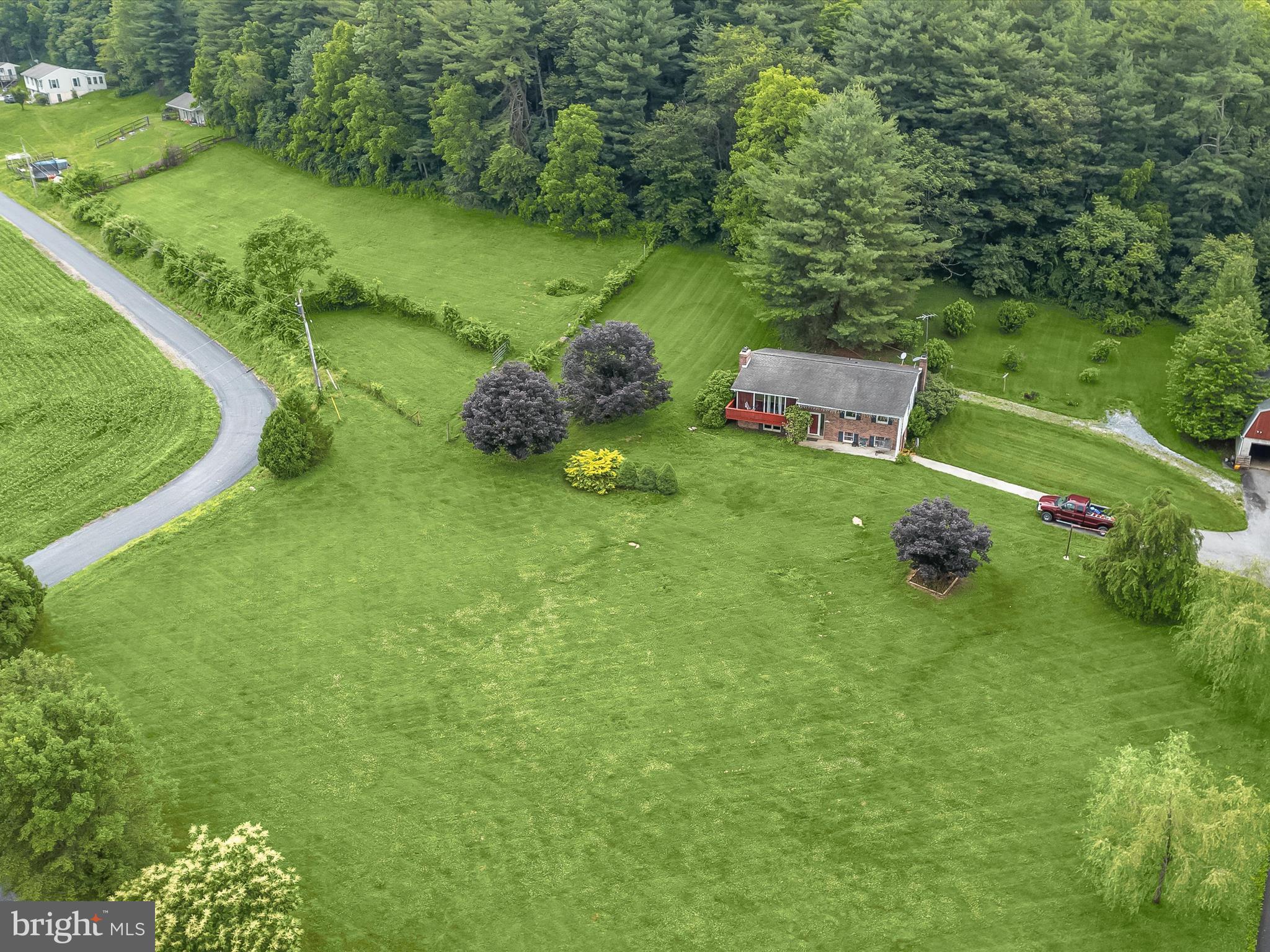 4704 Baughman Mill Road Manchester, MD 21102 - Photo 6 of 64 a backyard of a house with a yard and lake view