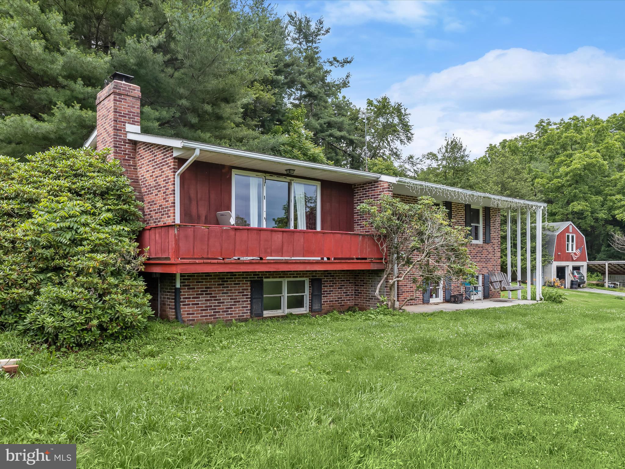 4704 Baughman Mill Road Manchester, MD 21102 - Photo 9 of 64 a front view of a house with a garden and yard