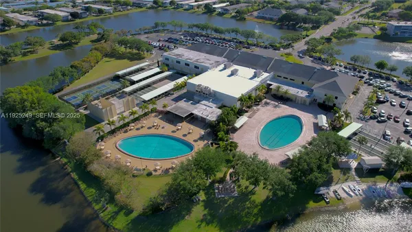 an aerial view of a house with swimming pool and outdoor space