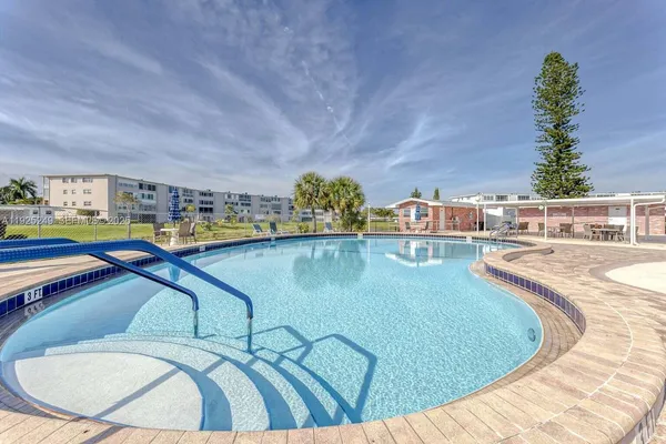 a view of a swimming pool with seating area