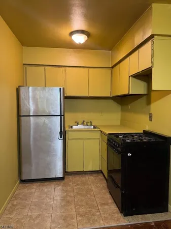 a kitchen with a refrigerator and a stove
