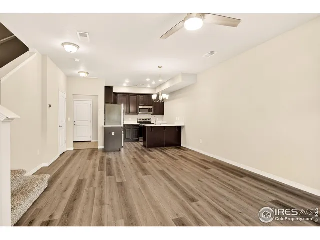 a view interior of a house with kitchen space microwave and a refrigerator