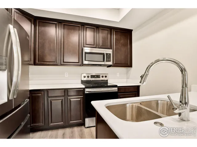 a kitchen with a stove a sink and a microwave