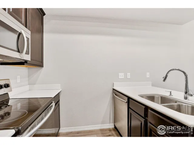 a kitchen with a sink cabinets and microwave