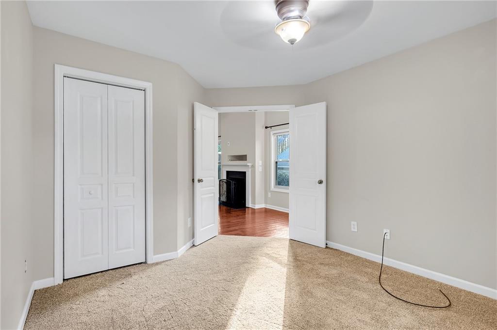 429 Arrowhead Trail Canton, GA 30114 - Photo 11 of 25 an empty room with a ceiling fan and closet area