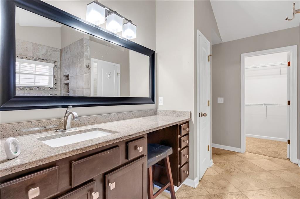 429 Arrowhead Trail Canton, GA 30114 - Photo 19 of 25 a en suite bathroom with a granite countertop sink and a mirror