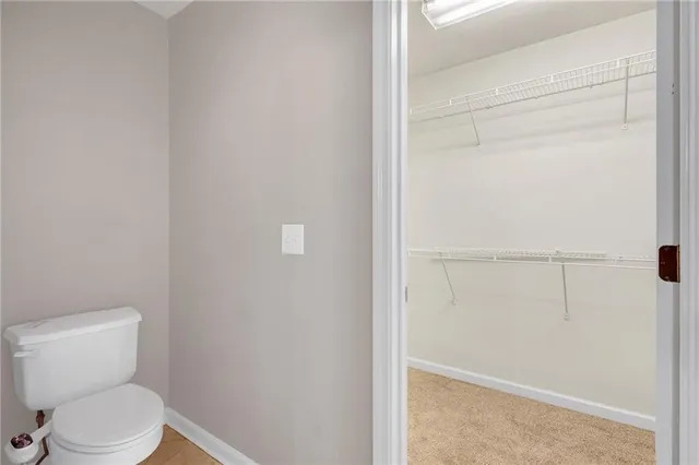 a white toilet sitting next to a shower
