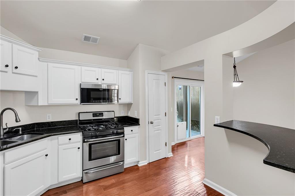 429 Arrowhead Trail Canton, GA 30114 - Photo 7 of 25 a kitchen with granite countertop a sink cabinets and stainless steel appliances