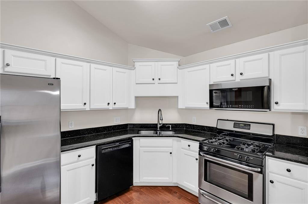 429 Arrowhead Trail Canton, GA 30114 - Photo 9 of 25 a kitchen with white cabinets and appliances