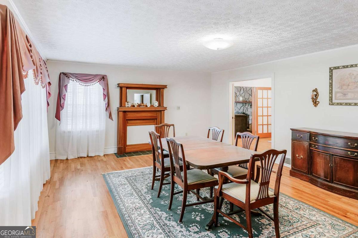 119 Ralph Bridges Road Lexington, GA 30648 - Photo 17 of 65 a dining room with furniture and wooden floor