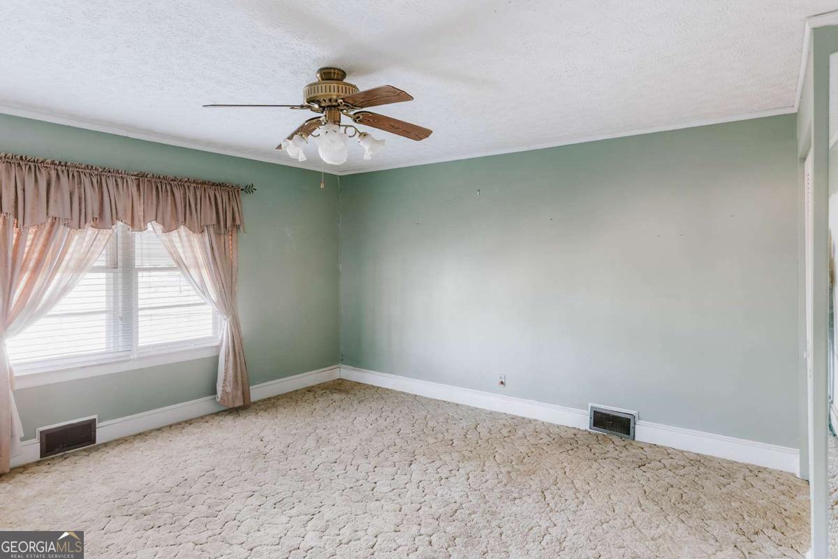 119 Ralph Bridges Road Lexington, GA 30648 - Photo 28 of 65 an empty room with a window