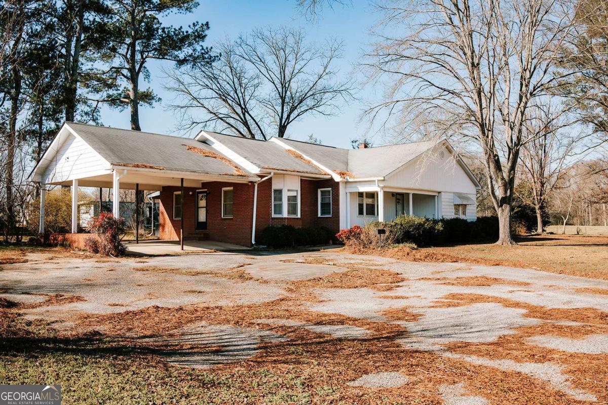 119 Ralph Bridges Road Lexington, GA 30648 - Photo 3 of 65 a front view of a house with a yard covered with snow and trees