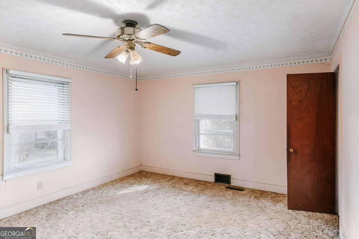 119 Ralph Bridges Road Lexington, GA 30648 - Photo 31 of 65 an empty room with windows and fan