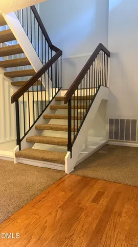 a view of a dining room with furniture and a chandelier