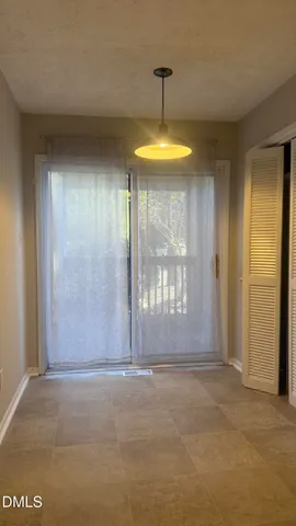 a view of empty room with a window and ceiling fan