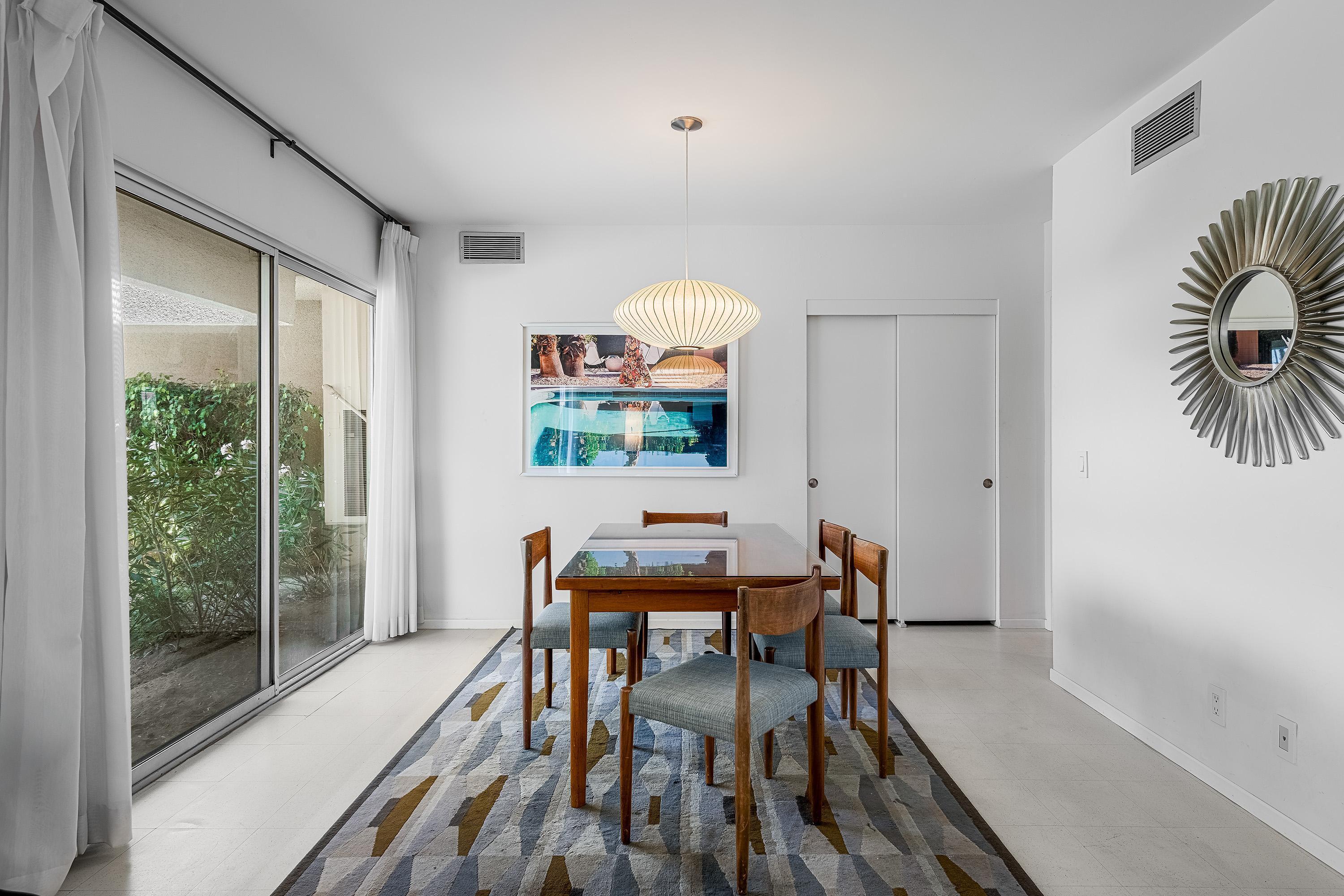 1855 Ramon Road, Unit 14 Palm Springs, CA 92264 - Photo 12 of 34 a dining room with furniture and wooden floor