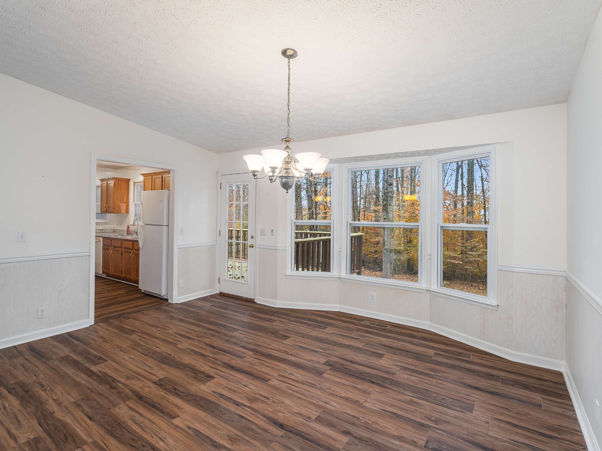 7125 Sutton Place Fairview, TN 37062 - Photo 14 of 36 a view of an empty room with wooden floor and a window