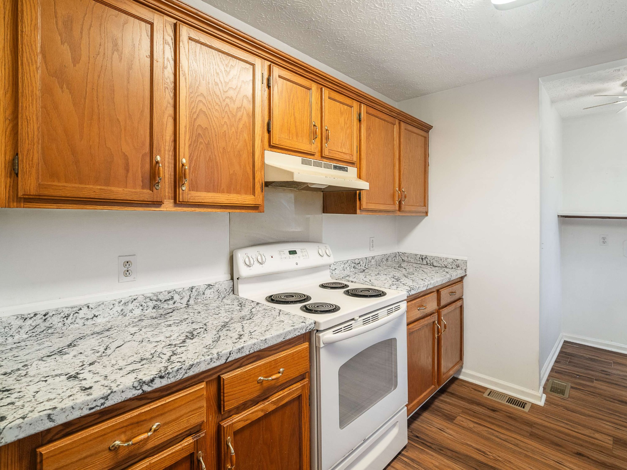 7125 Sutton Place Fairview, TN 37062 - Photo 16 of 36 a kitchen with granite countertop cabinets stainless steel appliances and a sink