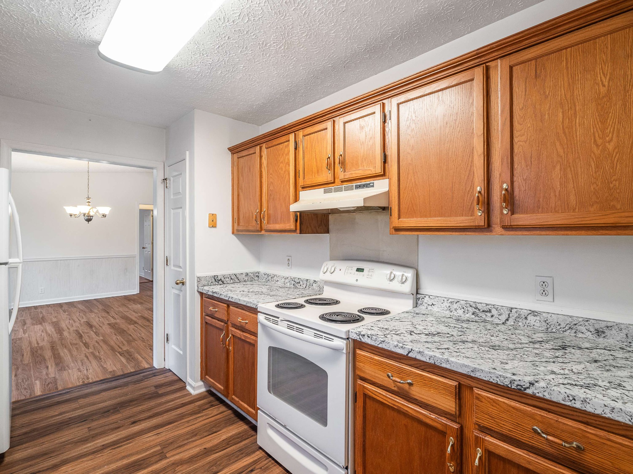 7125 Sutton Place Fairview, TN 37062 - Photo 18 of 36 a kitchen with stainless steel appliances granite countertop a stove a sink and a microwave