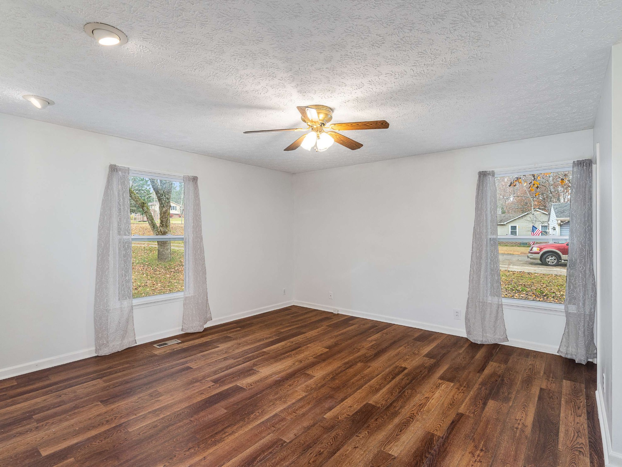 7125 Sutton Place Fairview, TN 37062 - Photo 20 of 36 a view of an empty room with window and wooden floor