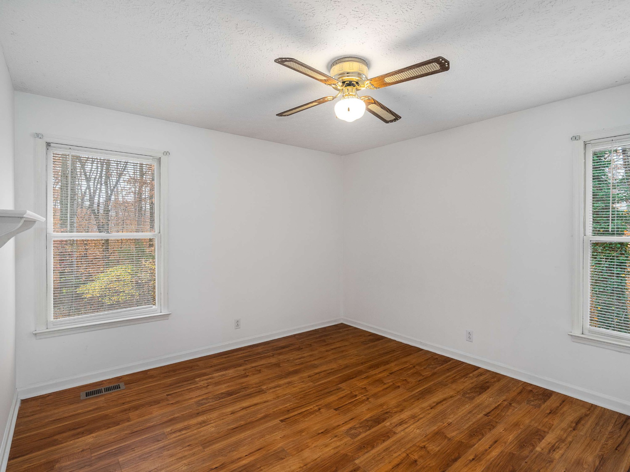 7125 Sutton Place Fairview, TN 37062 - Photo 25 of 36 a view of empty room with wooden floor and fan