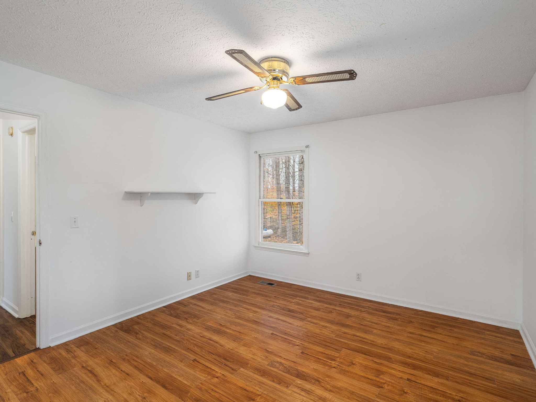 7125 Sutton Place Fairview, TN 37062 - Photo 26 of 36 an empty room with wooden floor fan and windows