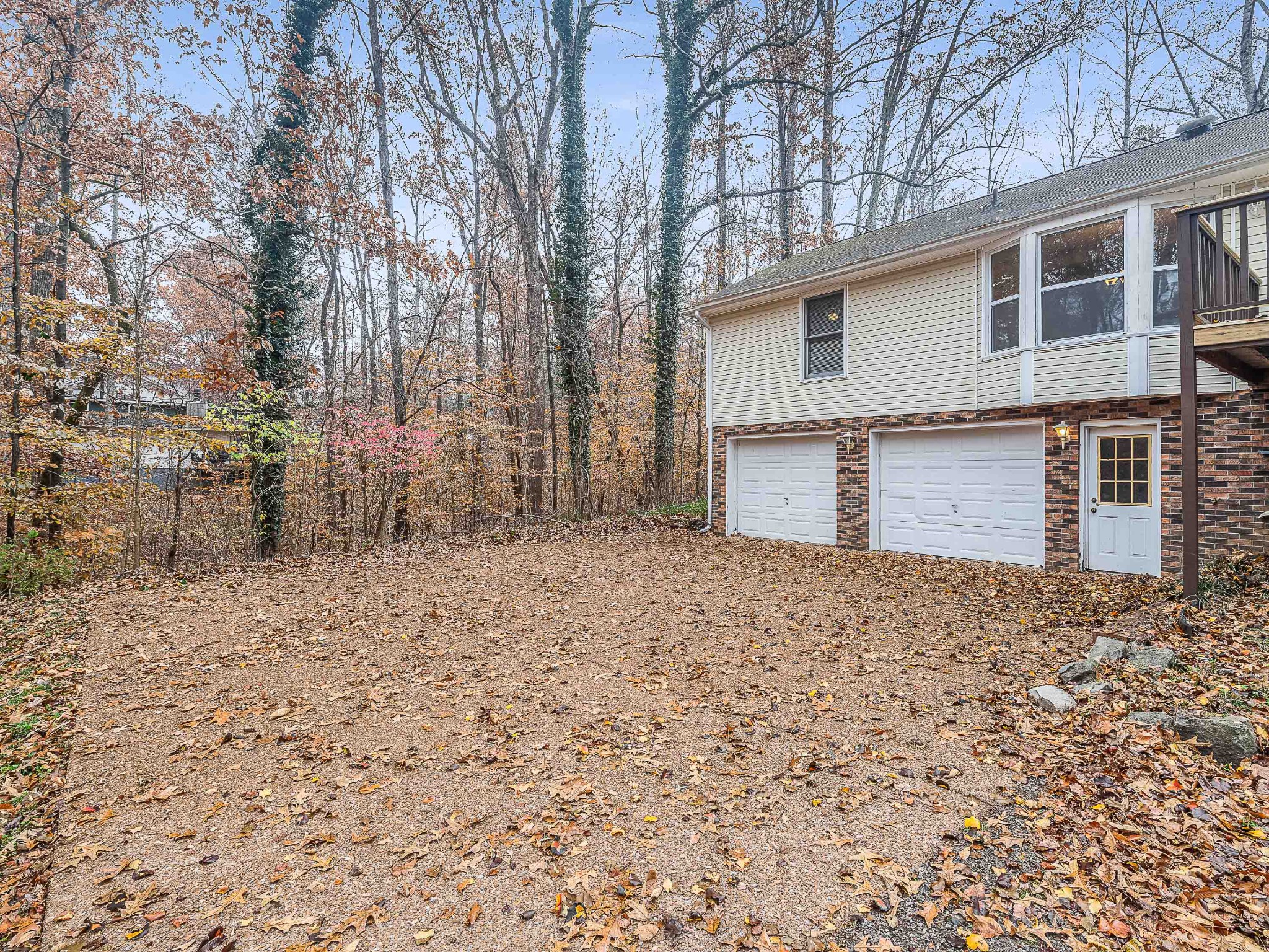 7125 Sutton Place Fairview, TN 37062 - Photo 6 of 36 a backyard of a house with large trees and wooden fence