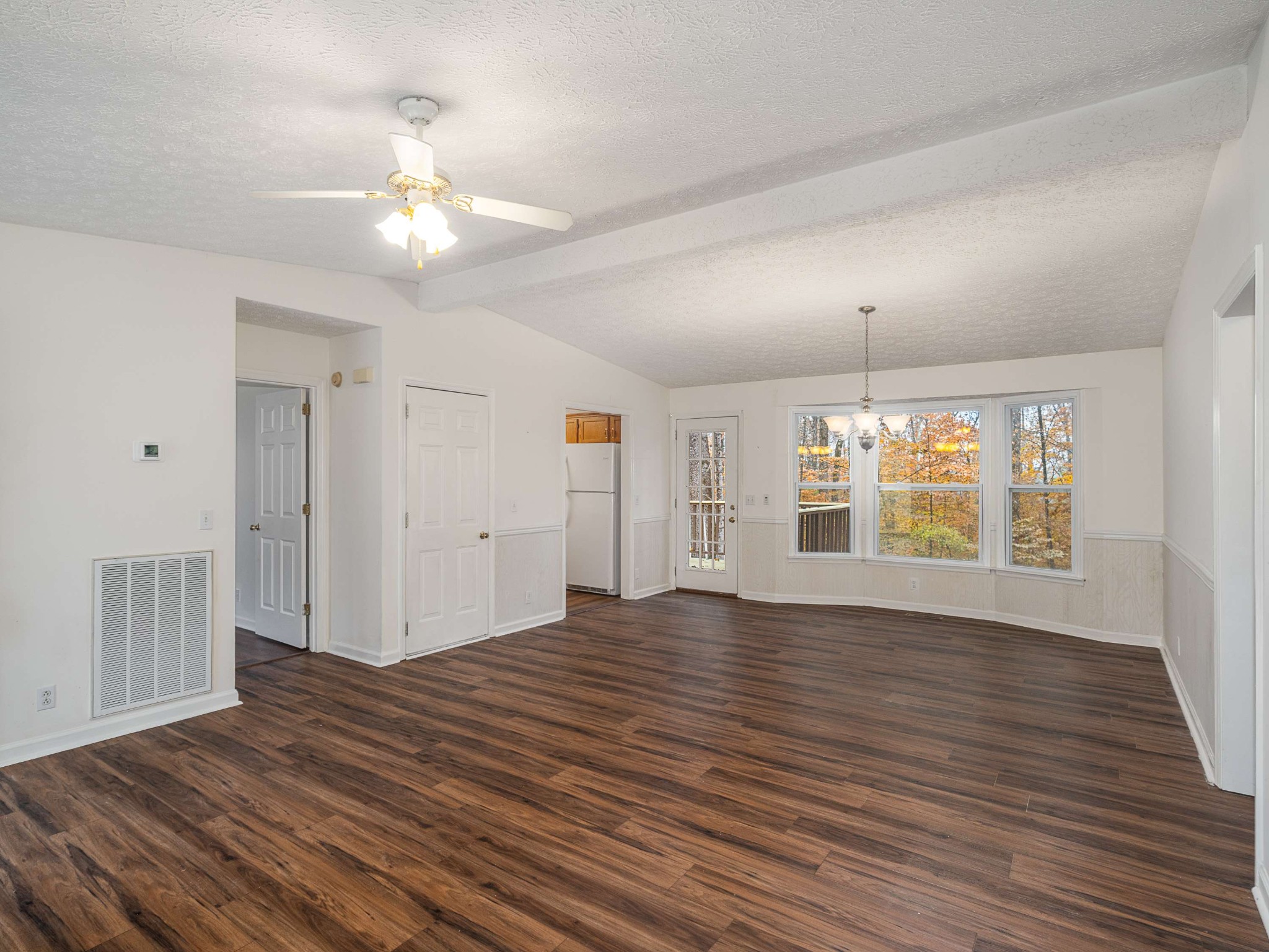 7125 Sutton Place Fairview, TN 37062 - Photo 10 of 36 a view of an empty room with wooden floor and a window