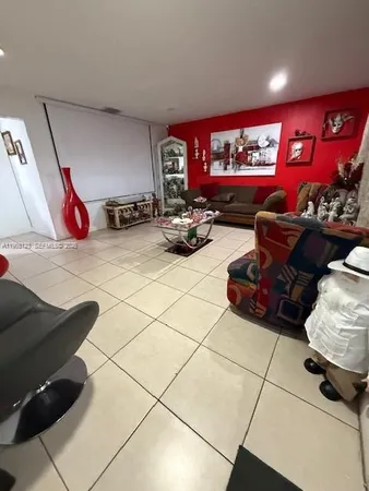 a living room with furniture and a gym equipment