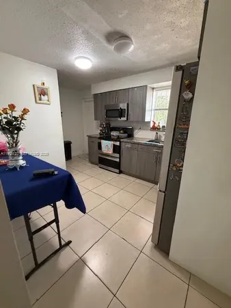 a kitchen with stainless steel appliances granite countertop a sink and a stove