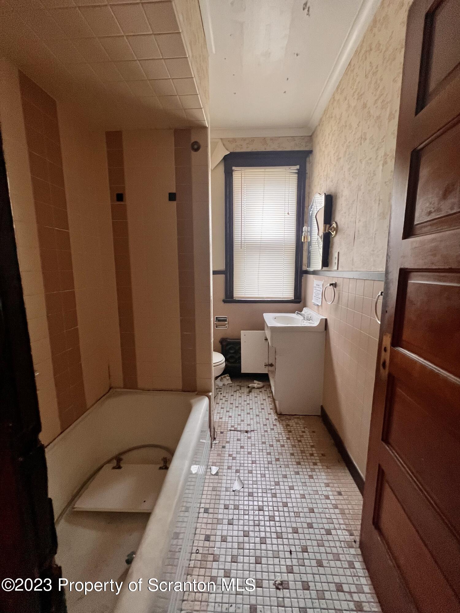 352-354 Maple Street Scranton, PA 18505 - Photo 12 of 22 a bathroom with a sink toilet and tub